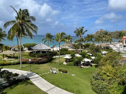 Palm trees, green lawns and a turquoise bay at a resort in St. Lucia