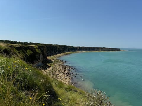 Green cliffs above a turquoise bay