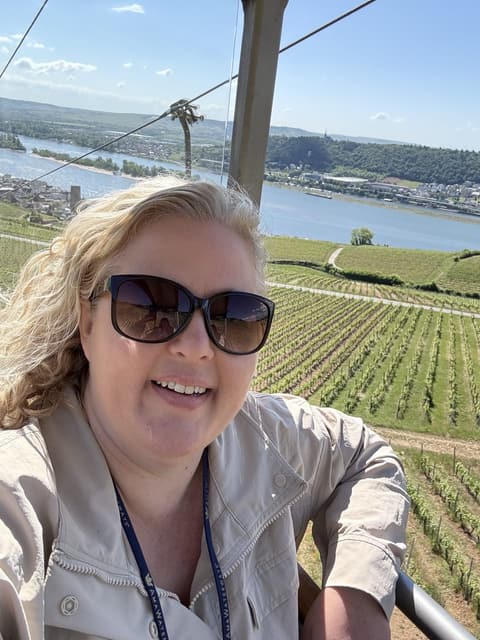 Michelle McAllister smiling on a gondola above the Rhine vineyards